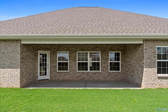 rear view of property with a patio and a yard