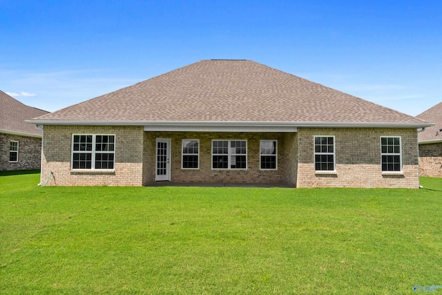 back of house with a lawn