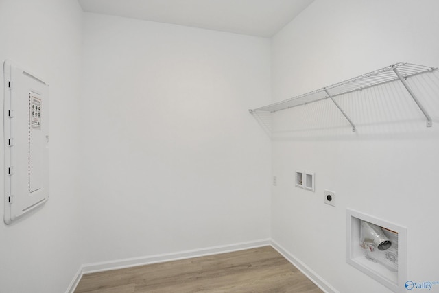 laundry room with electric panel, hardwood / wood-style floors, washer hookup, and hookup for an electric dryer