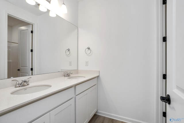 bathroom with hardwood / wood-style flooring and vanity