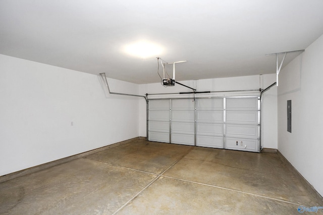 garage featuring electric panel and a garage door opener