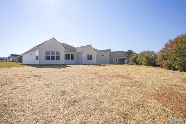 rear view of house with a lawn