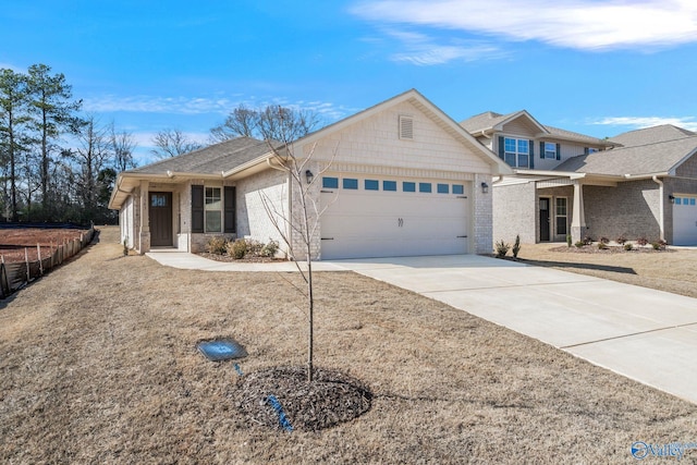 view of front of property featuring an attached garage, concrete driveway, and brick siding