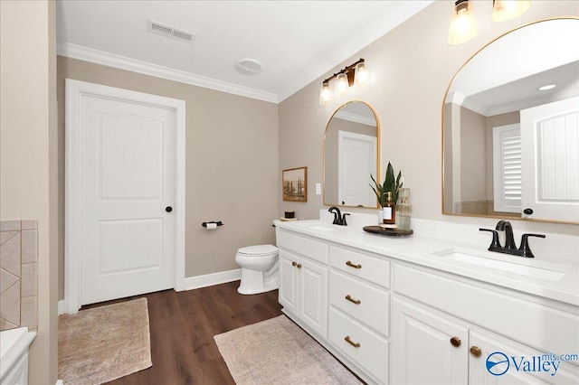 bathroom with toilet, vanity, hardwood / wood-style flooring, and crown molding