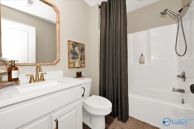 full bathroom featuring vanity, shower / bath combo with shower curtain, and toilet