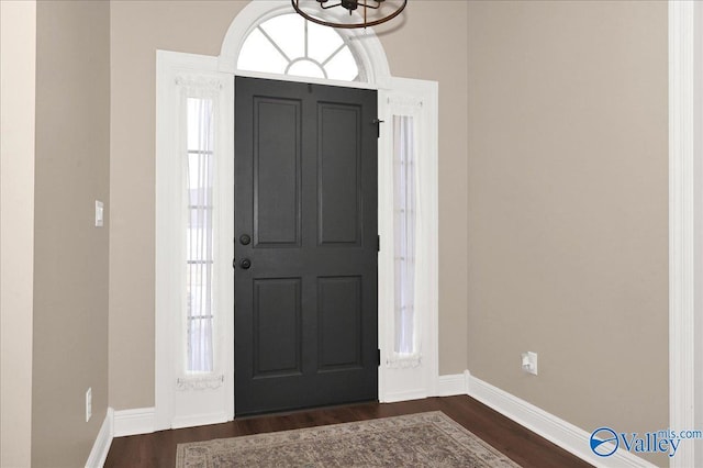 foyer featuring a notable chandelier and dark hardwood / wood-style floors