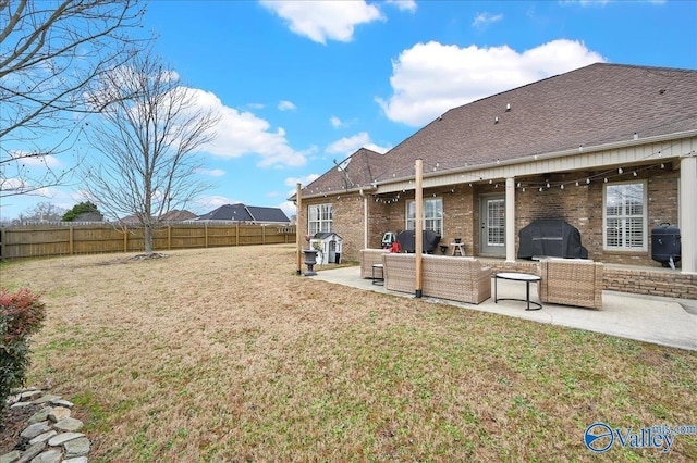 back of house featuring a patio and a yard