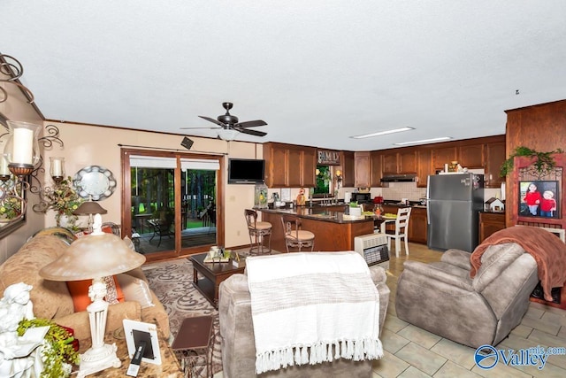 living room featuring a ceiling fan and light tile patterned flooring