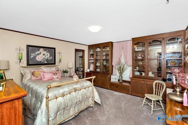 bedroom featuring ornamental molding, carpet flooring, and a textured ceiling