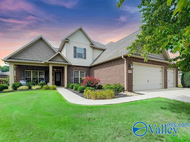 craftsman-style home featuring a lawn and a garage