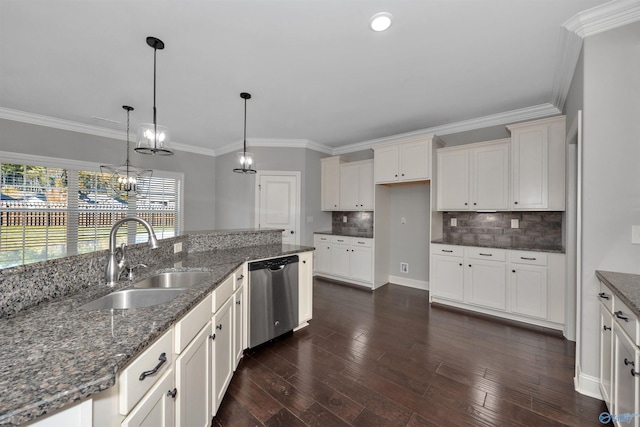 kitchen with pendant lighting, dark stone counters, sink, stainless steel dishwasher, and dark hardwood / wood-style flooring