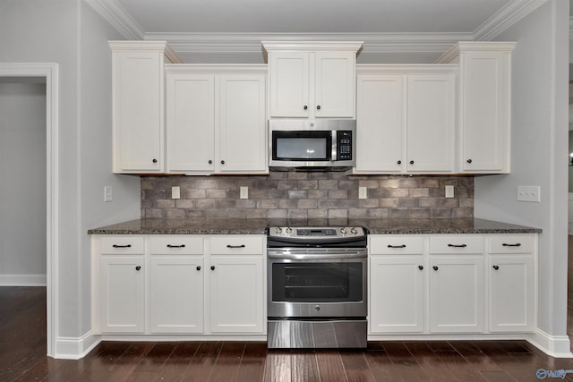 kitchen featuring stainless steel appliances, dark hardwood / wood-style floors, and dark stone counters