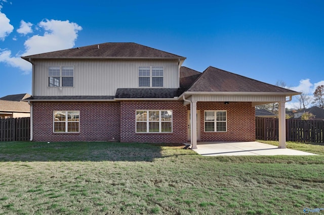 rear view of property featuring a patio and a lawn