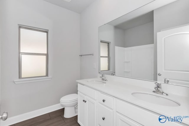 bathroom featuring hardwood / wood-style floors, vanity, and toilet