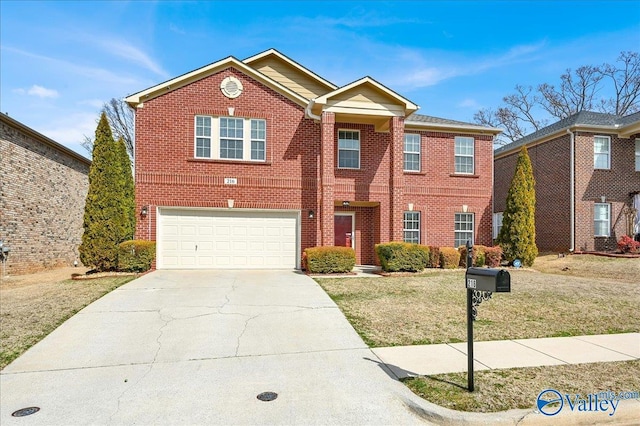 view of front of property with driveway, brick siding, an attached garage, and a front yard