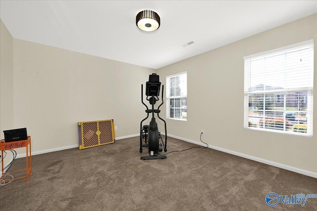 exercise room featuring carpet flooring, visible vents, and baseboards