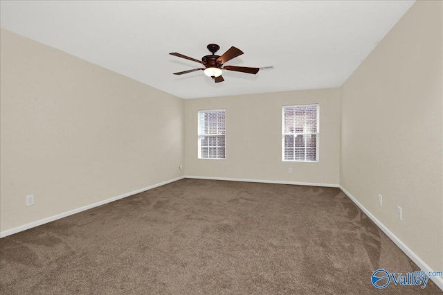 carpeted empty room featuring a ceiling fan, visible vents, and baseboards