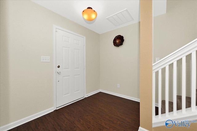 foyer with baseboards and dark wood finished floors