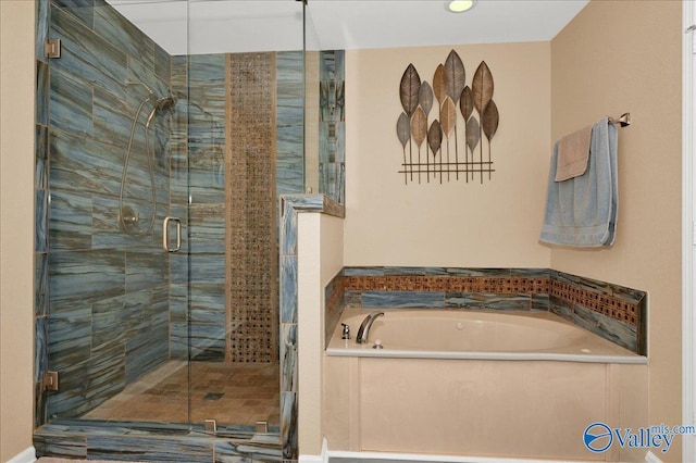 bathroom with a stall shower and a bath