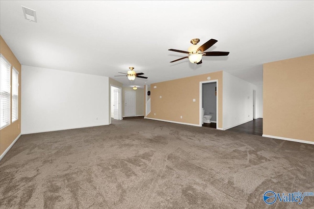 unfurnished living room featuring carpet, visible vents, ceiling fan, and baseboards