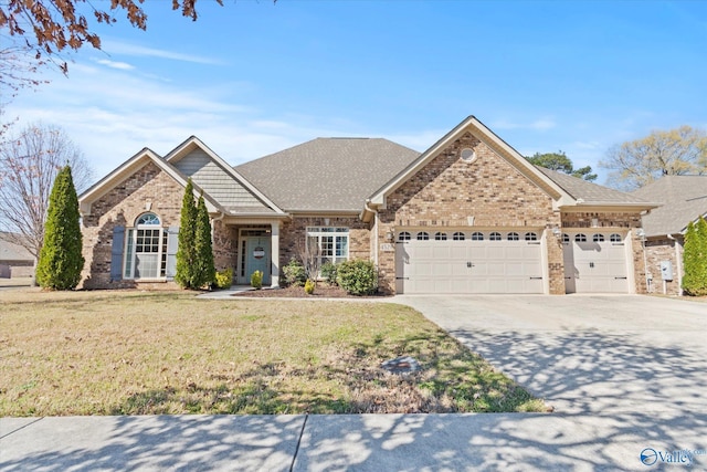 ranch-style home with concrete driveway, a shingled roof, an attached garage, a front yard, and brick siding