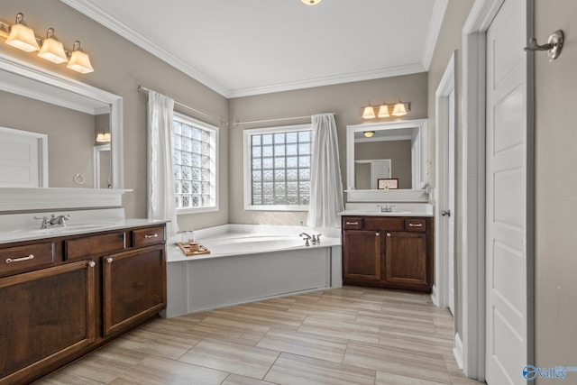 bathroom featuring two vanities, a garden tub, a sink, and crown molding