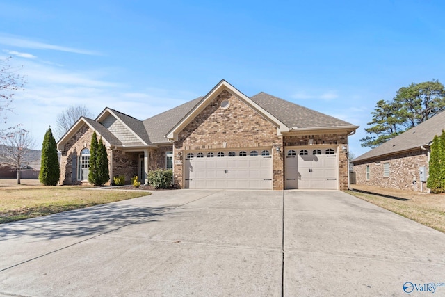 view of front facade featuring concrete driveway, a shingled roof, a front yard, brick siding, and a garage
