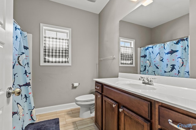 full bath with a shower with shower curtain, vanity, toilet, and baseboards