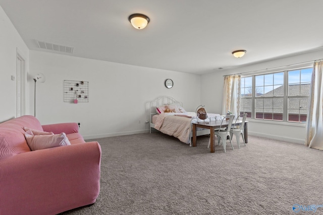carpeted bedroom featuring visible vents and baseboards