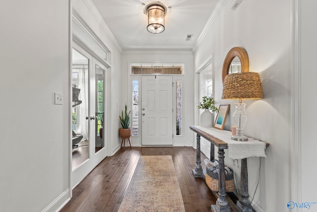 foyer entrance with french doors, dark wood-style flooring, baseboards, visible vents, and crown molding