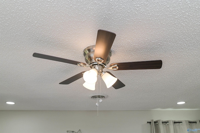 room details with visible vents and a textured ceiling