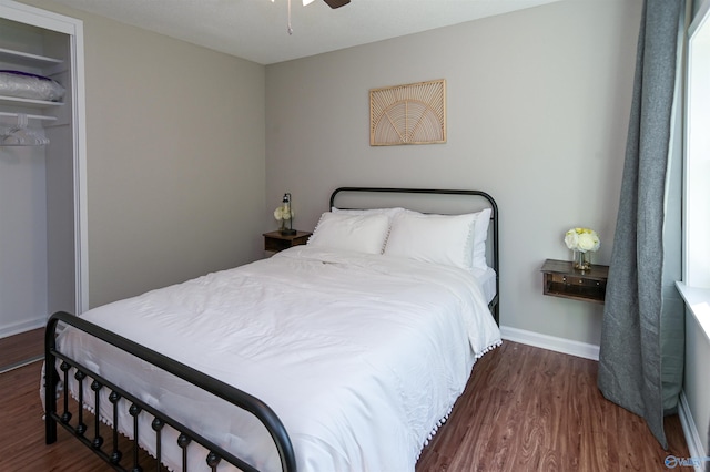 bedroom featuring a ceiling fan, baseboards, and wood finished floors