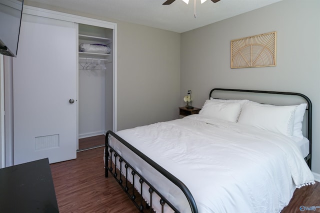 bedroom featuring ceiling fan, a closet, visible vents, and wood finished floors