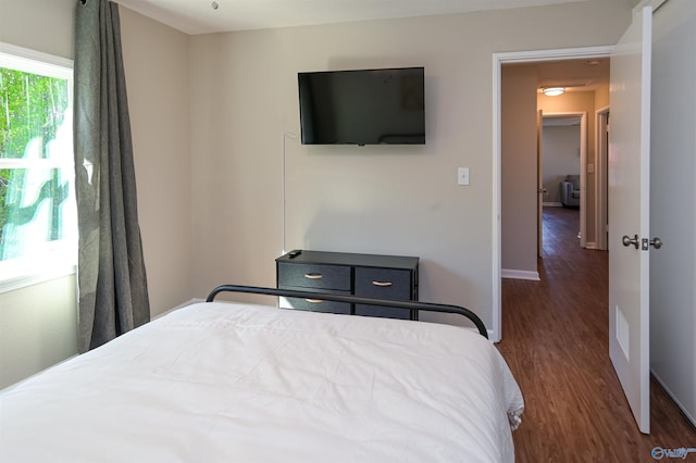 bedroom featuring baseboards and wood finished floors