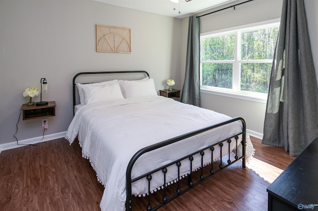 bedroom with baseboards and wood finished floors