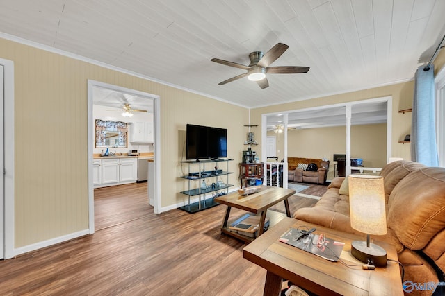 living room featuring hardwood / wood-style flooring, ornamental molding, sink, and wood ceiling