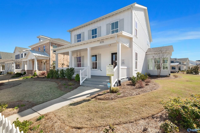 view of front of house with covered porch and a front yard