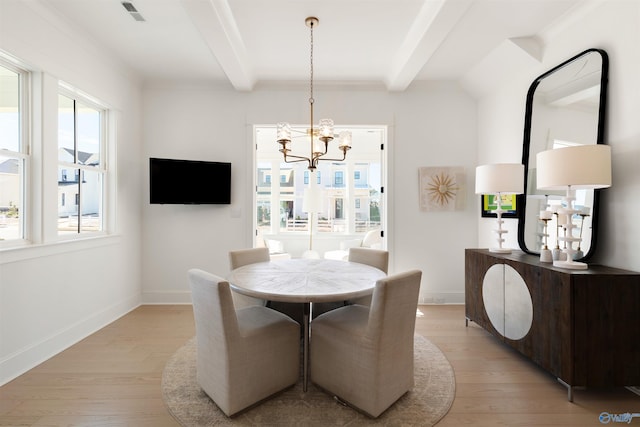 dining space featuring beamed ceiling, an inviting chandelier, and light wood-type flooring