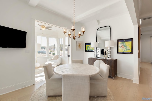 dining room featuring ceiling fan with notable chandelier and light wood-type flooring