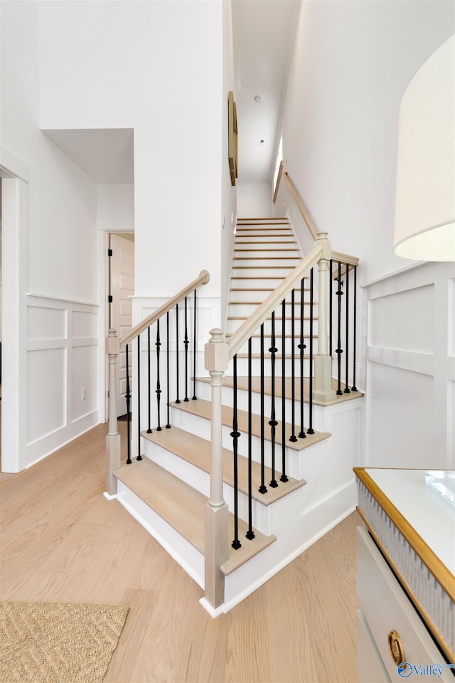 stairs featuring light wood-type flooring