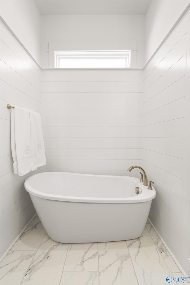 bathroom with plenty of natural light and a bathing tub