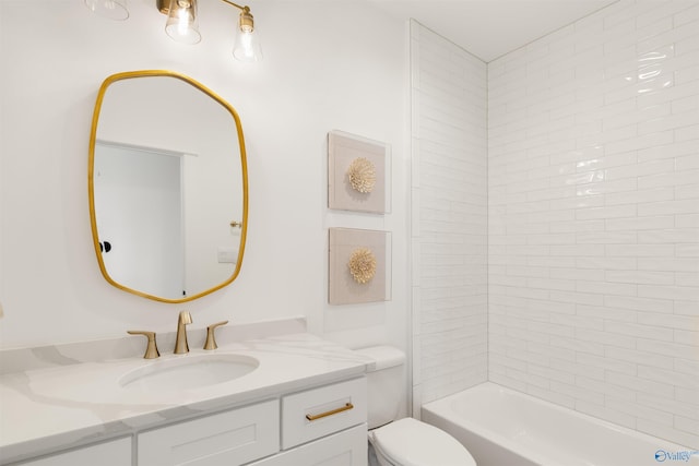 full bathroom featuring vanity, tiled shower / bath, and toilet