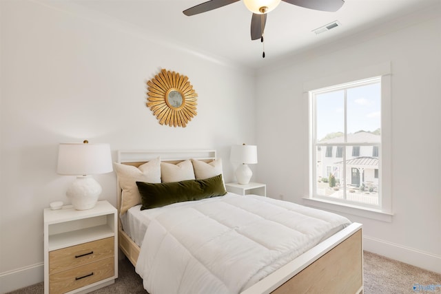 bedroom with ceiling fan and light carpet