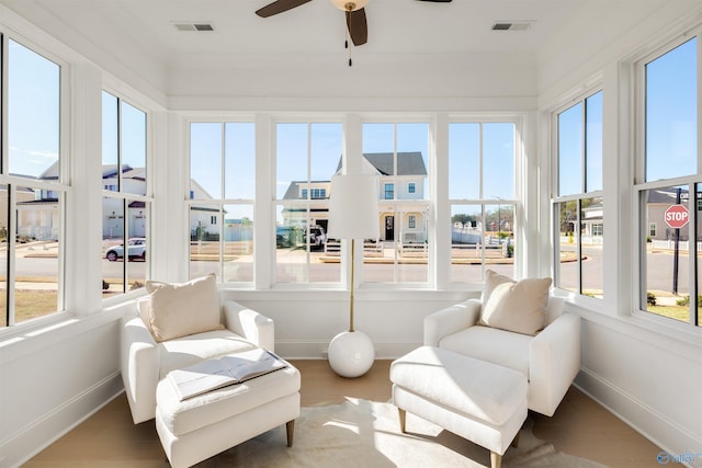 sunroom featuring ceiling fan and a wealth of natural light