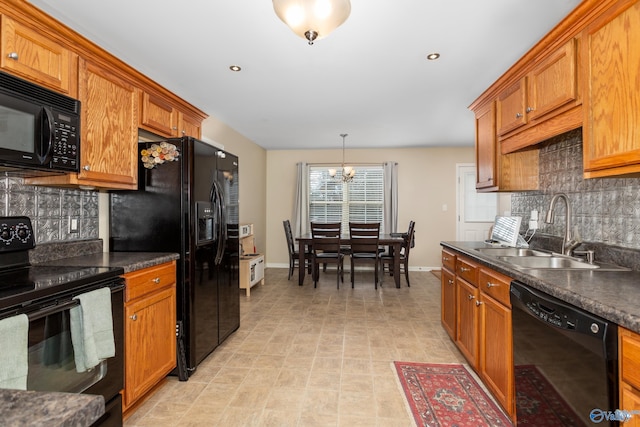 kitchen featuring black appliances, sink, decorative light fixtures, tasteful backsplash, and a notable chandelier