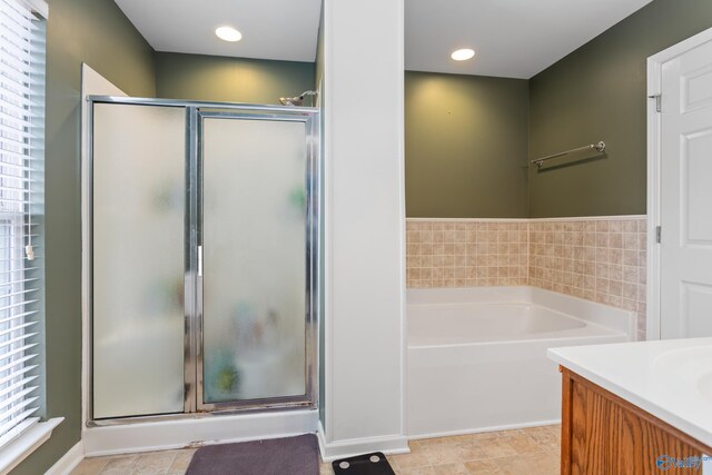 bathroom with separate shower and tub and vanity