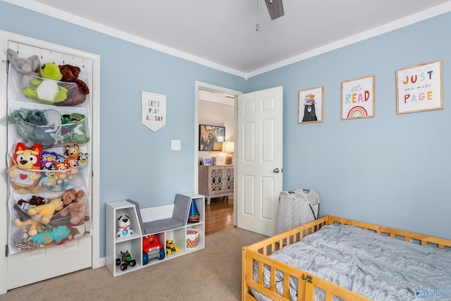 bedroom with carpet, ceiling fan, and crown molding