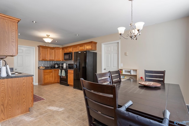 dining room with sink and an inviting chandelier