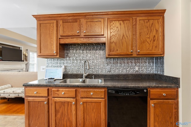 kitchen featuring tasteful backsplash, dishwasher, and sink