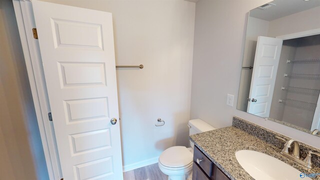 209 Roman Randall Rd, New Market, AL 35761 - half bathroom featuring toilet, wood finished floors, vanity, and visible vents